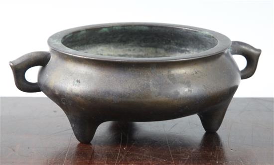 A Chinese brown patinated bronze ding censer, Xuande six character mark, probably 17th/18th century, width 21cm